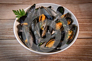Moules mariniere, mussels, with cream, garlic and parsley in a iron bowl