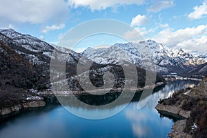 Mounains Lagoon Ancoa in the snow en region Maule, Chile. Aerial drone view