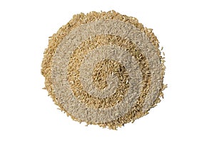 a mound pile of long grain brown rice on white table surface in natural sunlight with sharp details