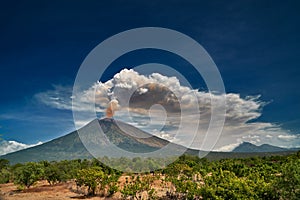 Mount Agung volcano dramatic eruption over dark blue sky