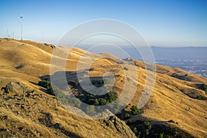 Mount Allison and the golden hills surrounding it on a sunny day; downtown San Jose in the background, south San Francisco bay,