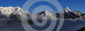 Mount Ama Dablam and other high mountains reaching out of a sea of fog