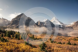 Mount Assiniboine with foggy in autumn forest at provincial park