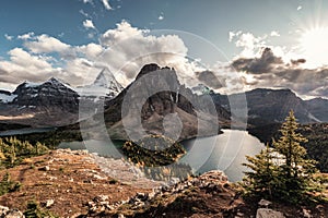 Mount Assiniboine with lake in autumn forest on Nublet peak at provincial park