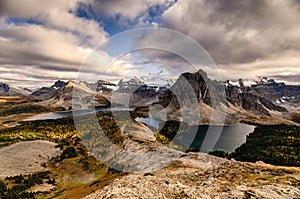 Mount Assiniboine with lake on Nublet peak in autumn forest on sunset at provincial park