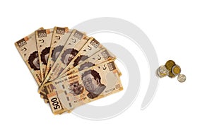 mount of bills against few coins little money