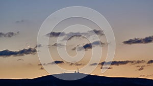 Mount Brocken silhouette at sunset in the winter evening. Harz mountain in Germany.