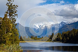 Mount Cook and Mount Tasman views from lake Matheson in a cloudy day, New Zealand