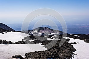 Mount Etna peak with snow and volcanic rocks, Sicily, Italy