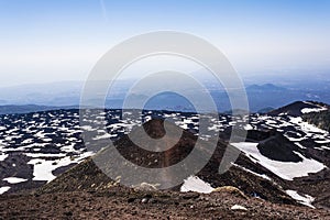 Mount Etna peak with snow and volcanic rocks, Sicily, Italy