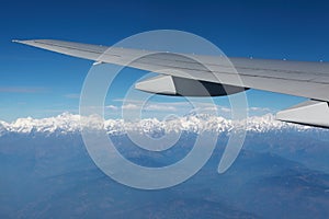 Mount Everest and airplane wing landscape viewed from aircraft window