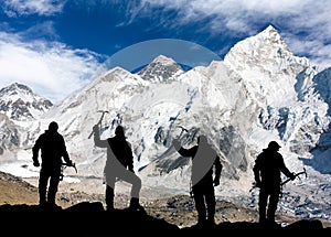 Mount Everest from Kala Patthar and silhouette of men