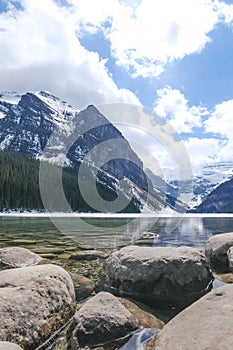 Mount fairview, partly frozen lake, rocks in foreground. Lake Louise Banff National Park, Alberta Canada