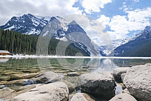 Mount fairview, partly frozen lake, rocks in foreground. Lake Louise Banff National Park, Alberta Canada