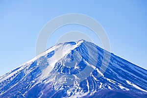 Mount Fuji. Beautiful Fuji mountain with snow cover on top with Bright blue sky, bright sunlight is background