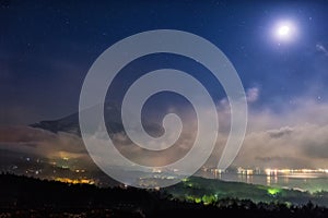 Mount Fuji with full moon and mist