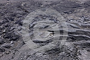 Textured surface of active volcano is covered with ash