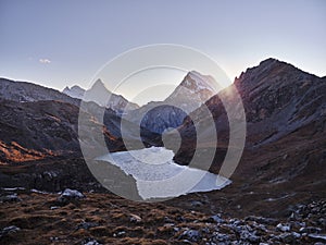 Mount jampayang and chanadorje and lake boyongcuo at sunset in yading national park, sichuan, china