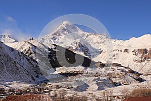 The Mount Kazbek and Gergeti village - the view from Stephantsminda, Georgia photo