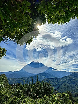 Mount Kinabalu with clouds and trees