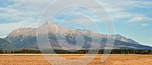 Mount Krivan peak Slovak symbol wide panorama with autumn dry field in foreground, Typical autumnal scenery of Liptov region,