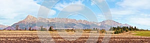 Mount Krivan peak Slovak symbol wide panorama with autumn dry field in foreground, Typical autumnal scenery of Liptov region,