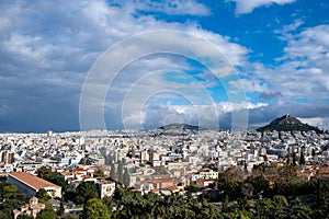 Mount Lycabettus and Athens cityscape view from Areopagus hill in Greece, blue cloudy sky