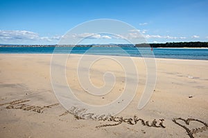 Mount Maunganui and heart written in sand at base of mount