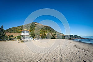 MOUNT MAUNGANUI, NEW ZEALAND - MARCH 6, 2020: The Surf Lifesaving tower stands ready on the Mount Main Beach on a beautiful sunny