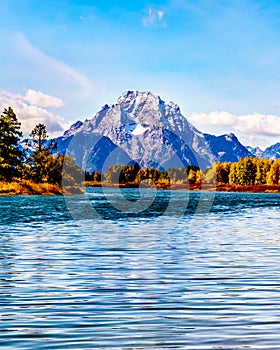 Mount Moran and surrounding Mountains in the Teton Mountain Range of Grand Teton National Park with Kayakers on the Snake River