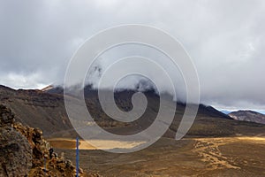 Mount Ngauruhoe covered behind clouds in the Tongariro National Park, New Zealand