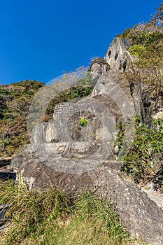 Mount Nokogiri Nokogiriyama Great Buddha Nihon-ji daibutsu. Carving of seated sculpture of Yakushi Nyorai. photo