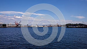 Mount Rainier and Seattle Logistics shipping terminals waterway. View from Elliott Bay during summer.