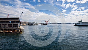 Mount Rainier and Seattle Logistics shipping terminals waterway. View from Elliott Bay during summer.