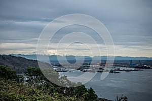 Mount Rainier Topped With Clouds With The Port Of Tacoma Below