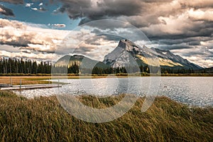 Mount Rundle with cloudy and wooden pier in Vermillion lake at Banff national park