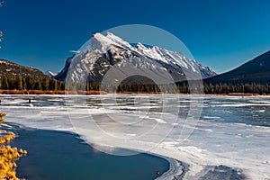 Mount Rundle and a partially frozen Vermillion Lakes. Banff National Park, Alberta, Canada