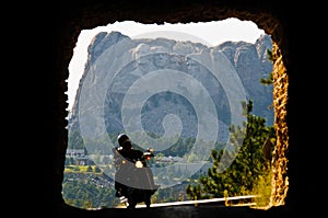 Mount Rushmore through tunnel with riders