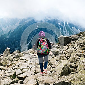 Mount Rysy Tatras Slovakia Woman traveler backpack tracking sticks top mountain