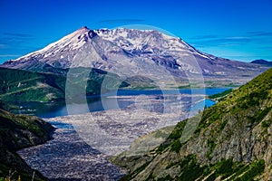Mount Saint Helens and Spirit Lake filled with logs in the foreground