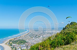 Mount to horizon with hang glider and paraglider soaring around summit