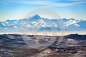 Mount Viso and Vineyard hills under snow in Langhe region in Ita