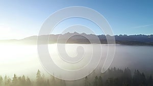 Mountain aerial, epic view. Aerial view of mountain landscape, flying through morning fog.