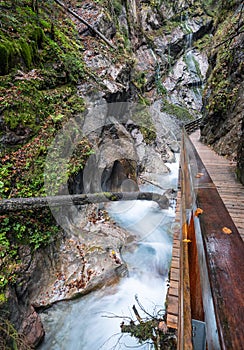 Mountain alpine autumn Wimbachklamm gorge and Wimbach stream with wooden path, Berchtesgaden national park, Alps, Bavaria, Germany