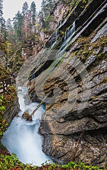 Mountain alpine autumn Wimbachklamm gorge and Wimbach stream with wooden path, Berchtesgaden national park, Alps, Bavaria, Germany