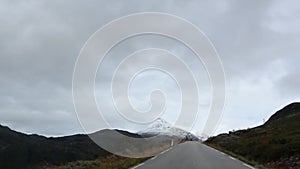 Mountain asphalt road, snow peaks Norway landscape
