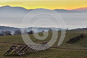 Mountain autumn landscape at dawn. With hay dryers in the foreground