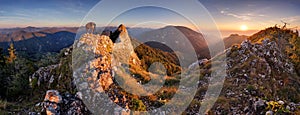 Mountain autumn panorama at sunset with forest and rocks.