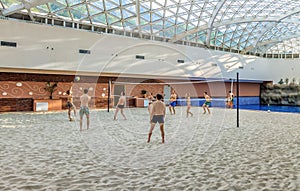 Mountain Beach Water Park in Gorky Gorod resort. Interior view with people playing volleyball on sand