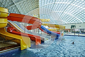 The Mountain Beach Water Park in Gorky Gorod resort. Interior view of water pool and water hill attractions.